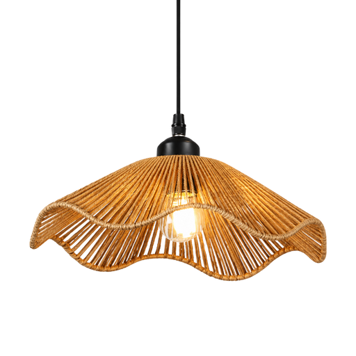 A pendant light with a natural woven rattan shade in a wavy scalloped edge, suspended by a black cord with a black metal cap, showing a glowing warm light bulb inside, isolated on a white background.