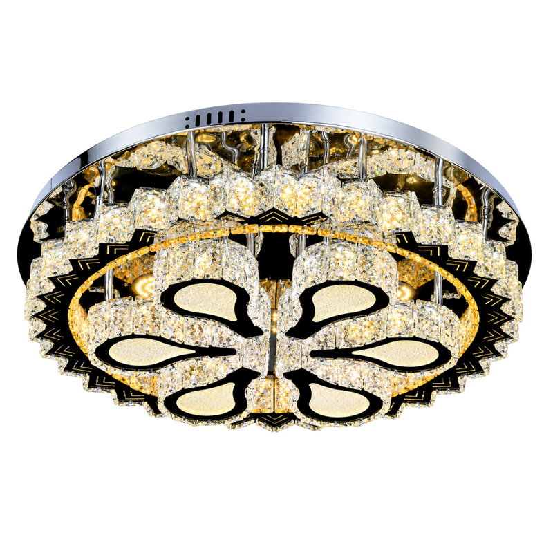 A round flush-mount ceiling light fixture with a polished chrome/silver outer rim, a black and gold geometric frame, and numerous clear crystal prisms that glow warm white. The center features a stylized floral or butterfly-like motif in black and gold over a background of clear crystals.