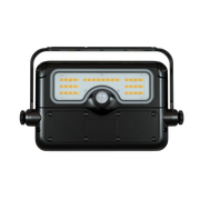 A black rectangular LED floodlight with a built-in handle, featuring a clear front lens with rows of warm yellow LED chips and a central motion sensor, shown against a plain white background.