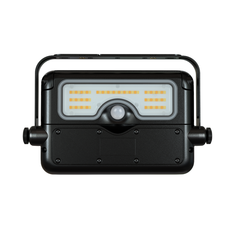 A black rectangular LED floodlight with a built-in handle, featuring a clear front lens with rows of warm yellow LED chips and a central motion sensor, shown against a plain white background.