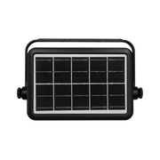 A rectangular solar-powered light fixture with a black housing, a silver border around the front panel, and a black solar panel grid, shown on a solid white background.
