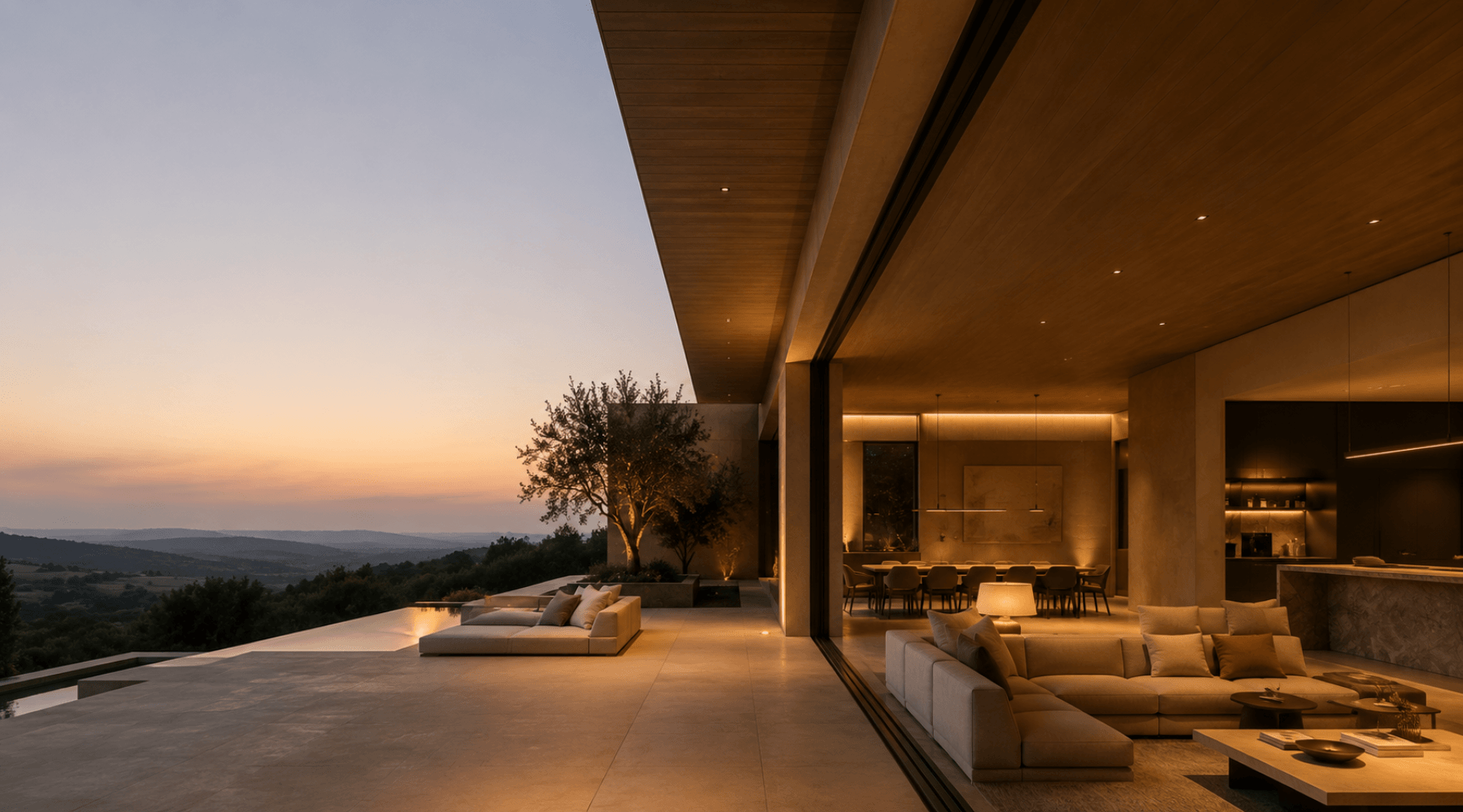 Modern outdoor living space with evening lighting and a scenic view.
