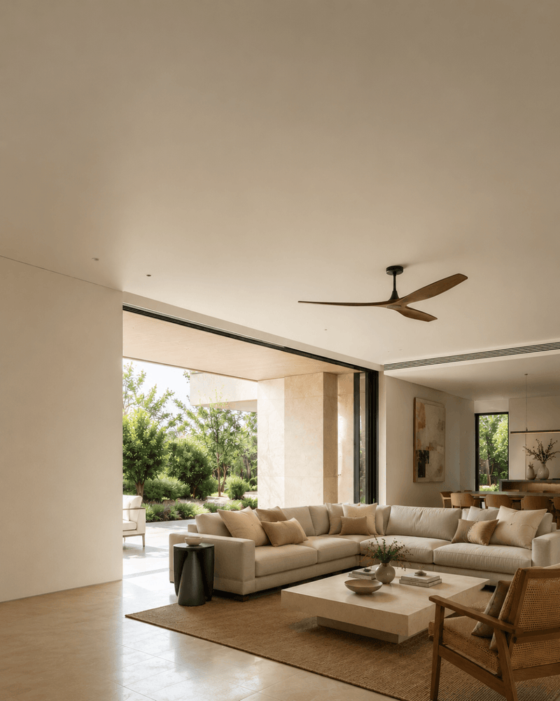 Modern living room with a sectional sofa, coffee table, and ceiling fan.